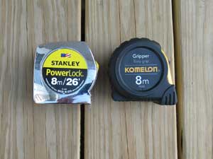 Two metric tape measures on outdoor deck